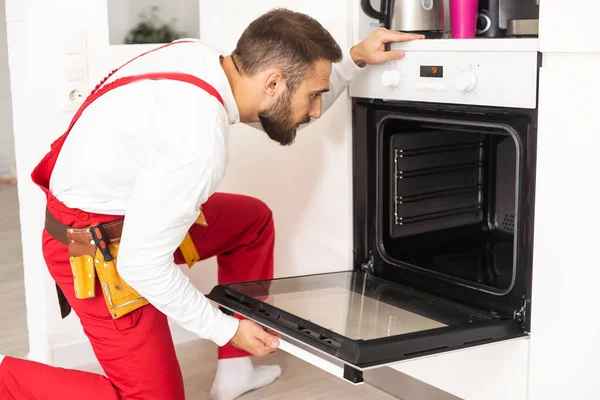 Repairman Examining Oven Screwdriver Kitchen Tool Case — Stock Fotó