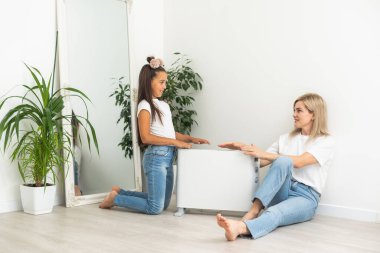 Family warming near electric heater at home