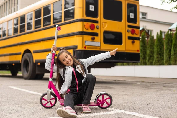 First day of school. Happy child girl elementary school student runs to class. concept back to school