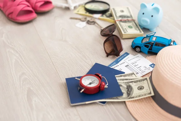 dollars, piggy bank, alarm clock, hat, glasses. Time to go on holiday. Things for summer trip