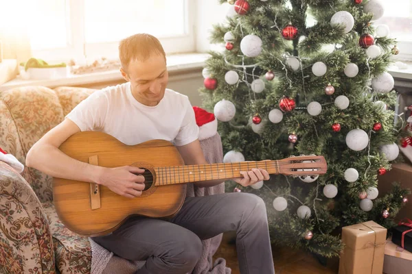 Young Handsome Man Sitting Sofa Playing Guitar Music Christmas Relax — Stock Photo, Image