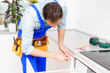 İşçi elektrikli sobayı tamir eder, Induction Soba.