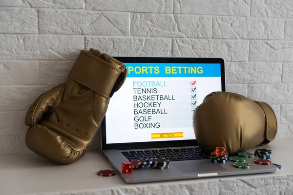 boxing gloves and a laptop with sports bets.