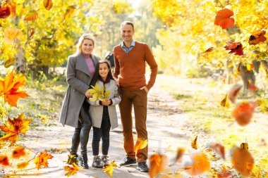 Family playing in autumn park having fun. High quality photo