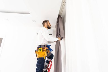 Pencere perde kapalı asılı adam. İç dekor öğesi.