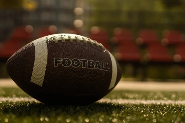 American football on football field background.