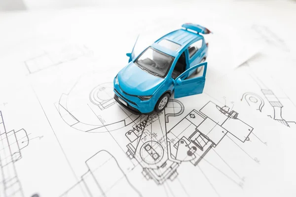 small car model and blueprint sheets