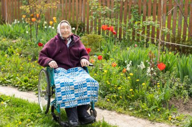Old woman sitting in a wheelchair looking sad and worried. depression, healthcare and caring for the elderly.
