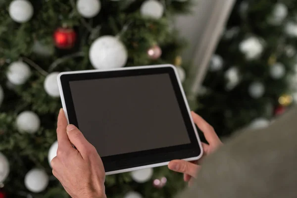 hands of a man holding blank tablet device