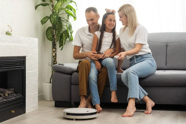 Young Family Resting Couch While Robotic Vacuum Cleaner Doing Its — Stock fotografie