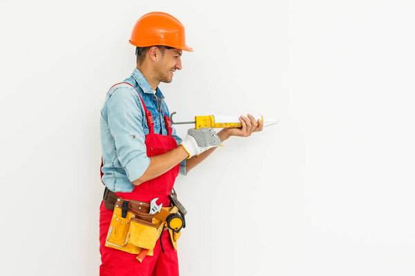 Young construction workers with hard hats on a white background.