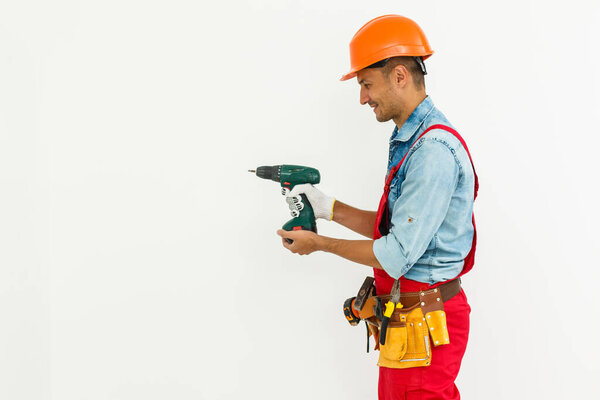 Young construction workers with hard hats on a white background.