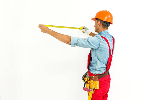 Worker in hard hat measure with ruler. Isolated on a white background.