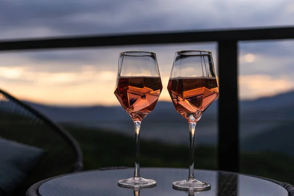 glasses of wine in mountains, closeup.
