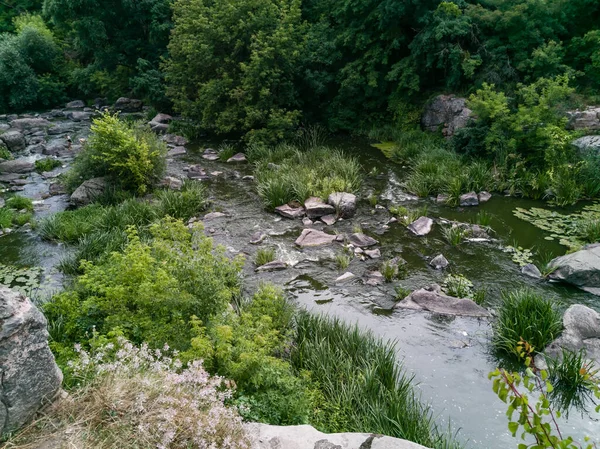 beautiful ripples on river flow over stones in summer.