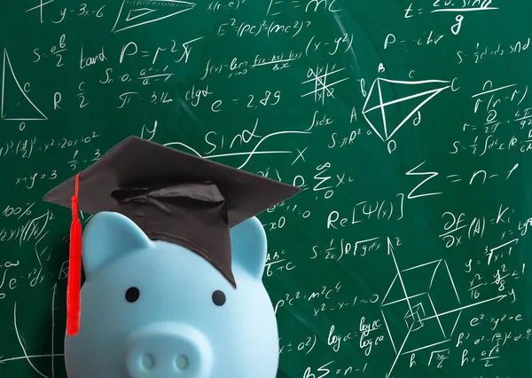 piggy bank in front of chalk board.
