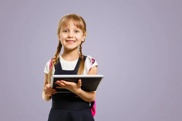 Smiling active excellent best student schoolgirl holding books and going to school wearing bag.