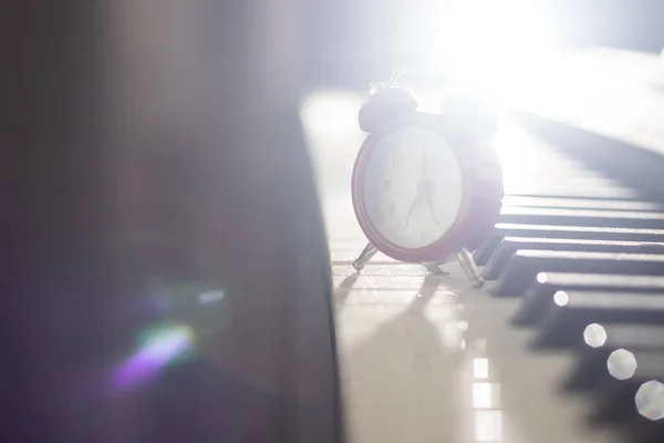 Piano and alarm clock, the time to practice the piano.