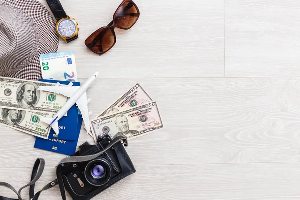 travel items are a compass, tickets, documents, money, a camera, a toy airplane. Planning of air travel, holidays, business trips. Advertising, banner