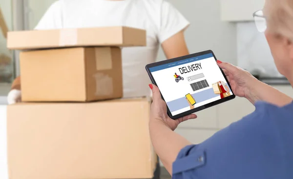 delivery, mail, people and shipping concept. Young woman sign in tablet after receiving parcel from courier at home