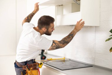 Erkek işçi mutfak mutfak Hood tornavida ile sabitleme.