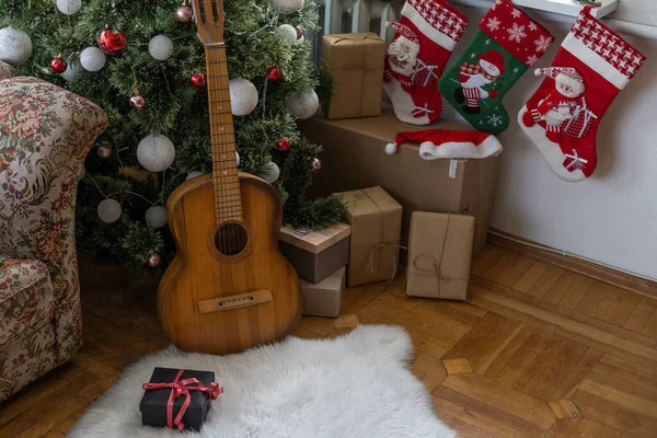 guitar with Christmas presents. Concept image for holiday musical event