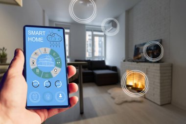 Akıllı bir evle ev ısısını kontrol etmek, telefonla yakın çekim yapmak. Evdeki akıllı aygıtları yönetmek için akıllı ev ve mobil uygulama kavramı.
