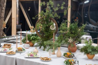 Place table setting for Christmas white table with decor elements with green branches Christmas tree.