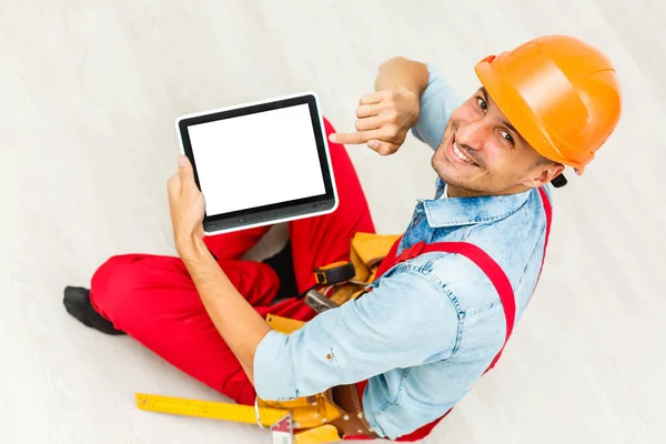 Construction worker holding digital tablet, repair, construction concept.