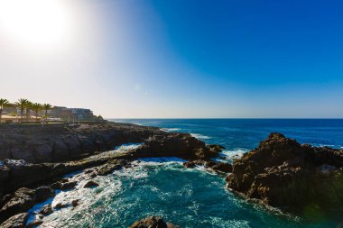 Denizde akşam sahnesi, taşlar, sakin okyanus.