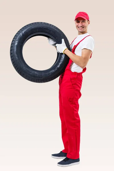 Working Man Full Growth Holds Tire White Background — Stock Photo, Image