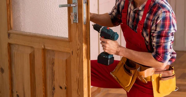 handyman repair the door in the room.