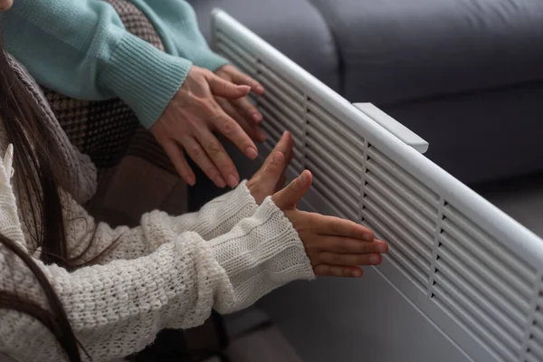 Family Warming Hands Electric Heater Home Closeup — Stock Photo, Image