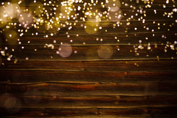 Ahşap Arka Planda Noel Önünde Sıcak Altın Renkli Çelenk Işıkları — Stok fotoğraf
