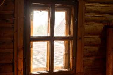 Odunlardan yapılmış, beyaz arka planı olan bir duvarda tahta bir pencere.