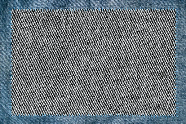 Тканина, прикріплена нитками до джинсів — стокове фото