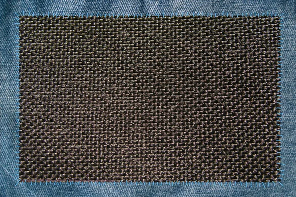 Тканина, прикріплена нитками до джинсів — стокове фото
