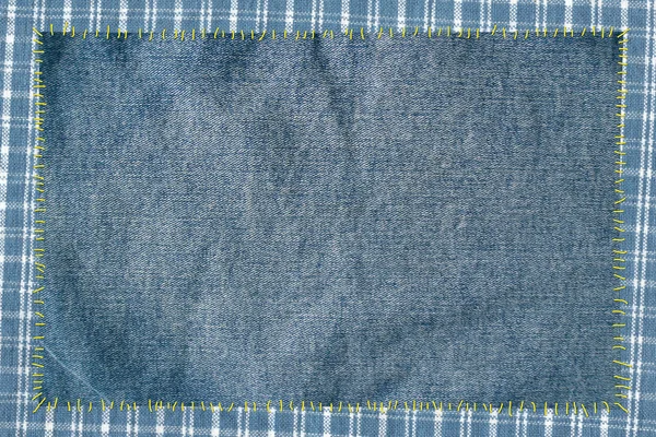 Cloth attached by threads to jeans — Stock Photo, Image