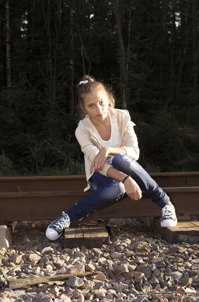 Girl sitting on railway — Stock Photo, Image