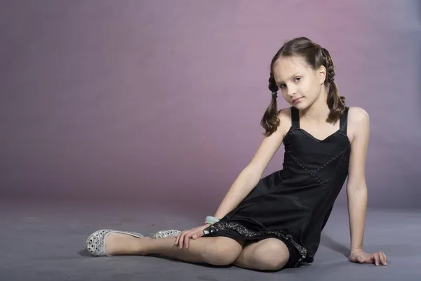 Nice girl in black dress in studio — Stock Photo, Image