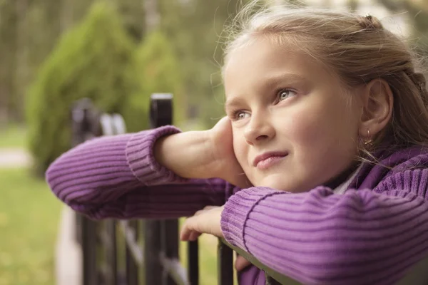 Nice girl staring outdoor in purple vest at autumn — Stock Photo, Image