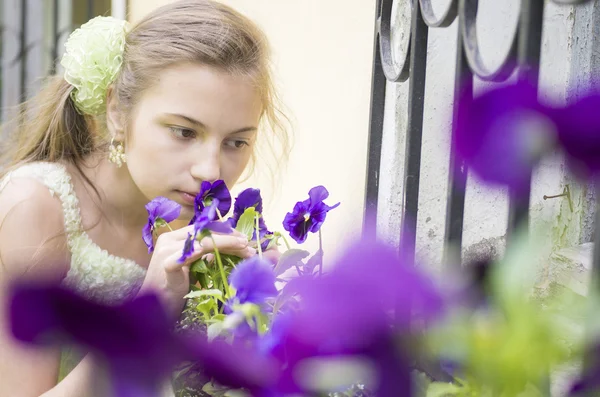 Young girl sniffing beautifull flowers — Stock Photo, Image