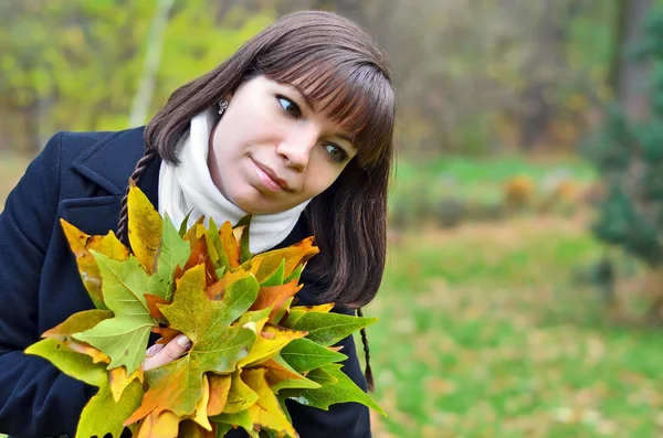 Junge Frau mit fallendem Laub — Stockfoto