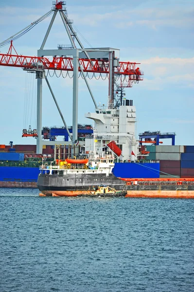 Tugboat assisting container cargo ship — Stock Photo, Image