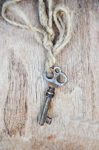 Vintage key on wooden background — Stock Photo, Image