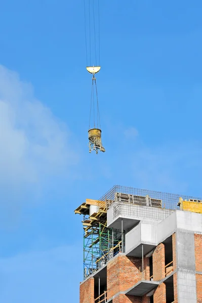 Crane lifting cement mixing container — Stock Photo, Image