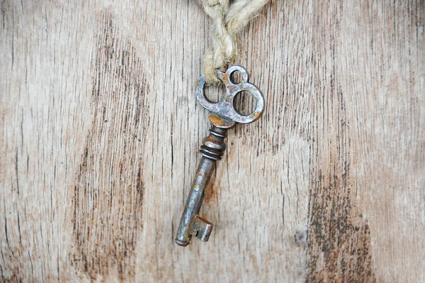 Vintage key on wooden background — Stock Photo, Image