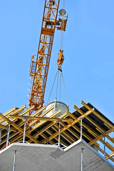 Crane lifting cement mixing container — Stock Photo, Image