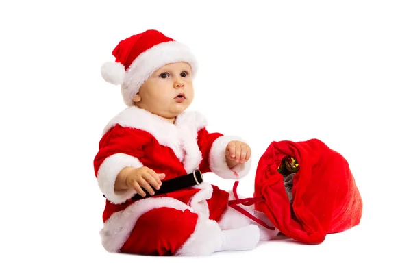 Pequeno Papai Noel com saco vermelho para presentes perto dele — Fotografia de Stock