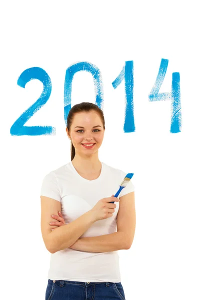 Young girl with brush in hand writes date — Stock Photo, Image
